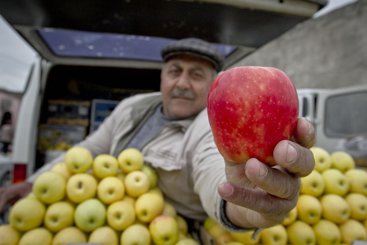 Торговец яблоками на рынке